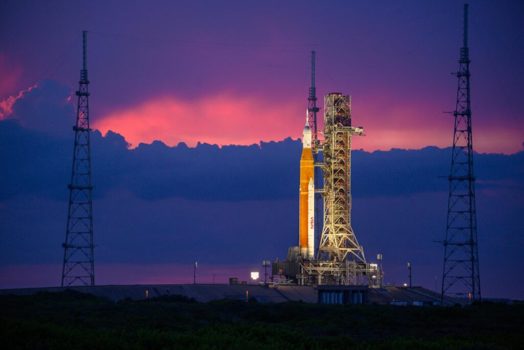 A rocket in front of a dramatic sunset