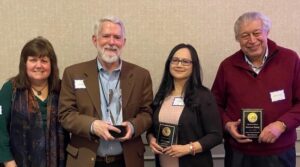 Photograph of Dena Maclung, Ron Hranac, July Candia and Dr. Mehmet Unsoy at the DAS spring banquet posing with their awards.